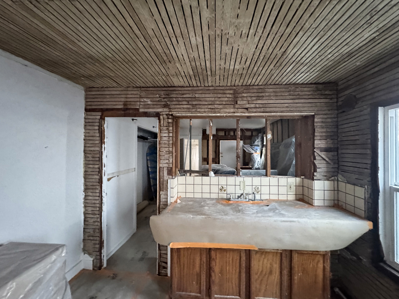 Interior renovation in progress with exposed historic lath